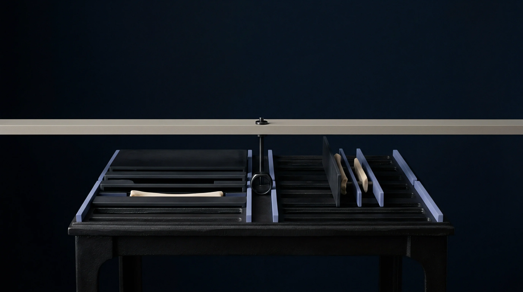 A precision inspection table holds organized specimen components under a horizontal calibration beam against a dark background.